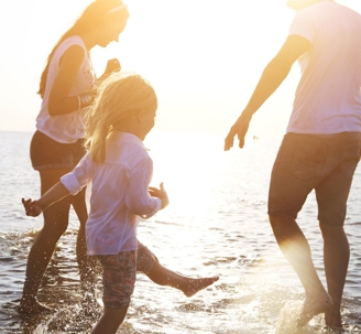 Family playing happily at the beach.